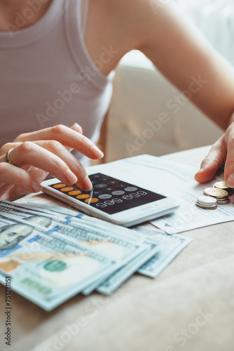 woman manages finances, expenses and saving, bills, taxes. invoices photo