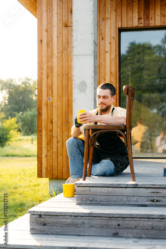 A man restores a chair using sandpaper