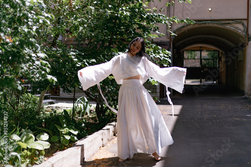 woman dancing in a white dress