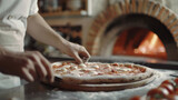 Chef skillfully preparing traditional pizza in a brick oven kitchen.