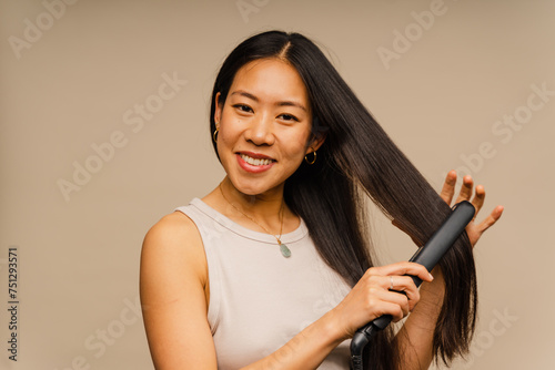 Asian Woman Using Hair Straightener