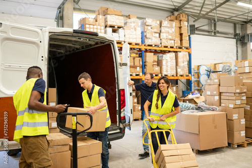 Logistic Workers Unloading Delivery Van While Driver Waiting photo