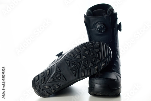 Black new snowboard boots on a white background. Active holidays.