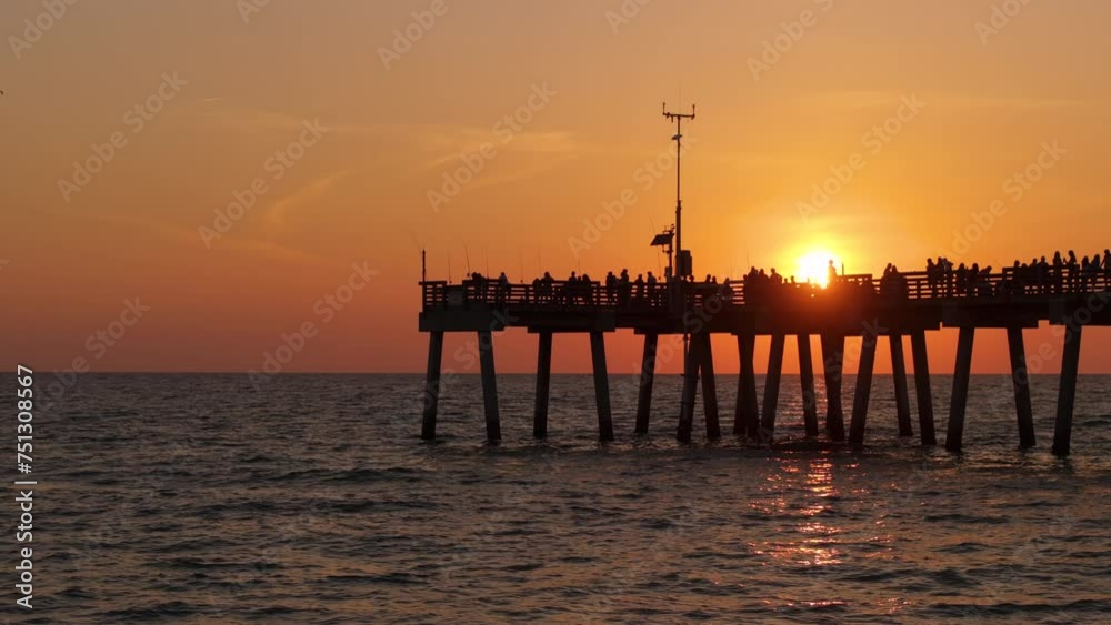 Fishermen enjoying vacation time on Venice fishing pier in Florida. Seaside summer activities Fishermen enjoying vacation time on Venice fishing pier in Florida. Seaside summer activities