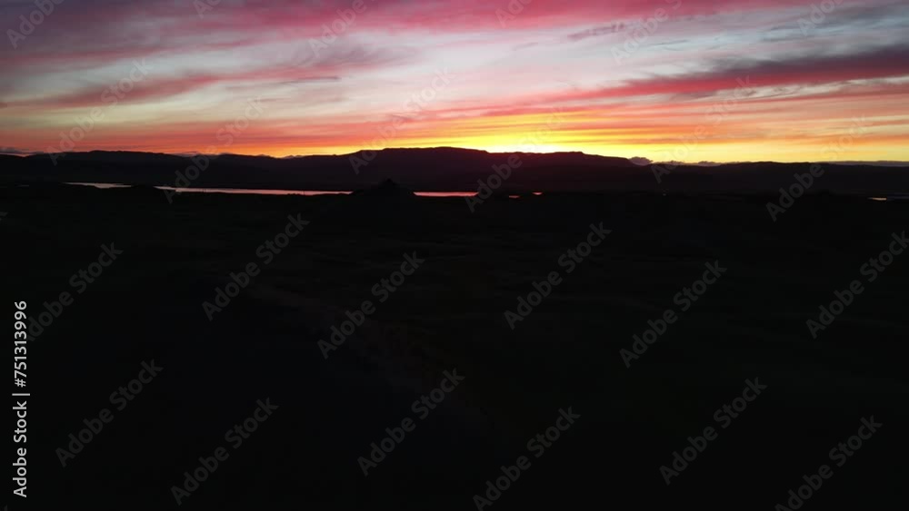 Stunning aerial shot of an orange sunset in Iceland. Amazing colors with the mountains and the reflection of the sky on the river. Stunning aerial shot of an orange sunset in Iceland. Amazing colors with the mountains and the reflection of the sky on the river.