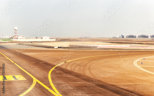 Runway and tarmac at Abu Dhabi airport at day. United Arab Emirates photo