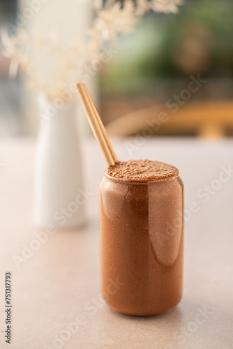 Chocolate smoothie on a coffee shop table. Vegan smoothie, healthy drink. Side view.