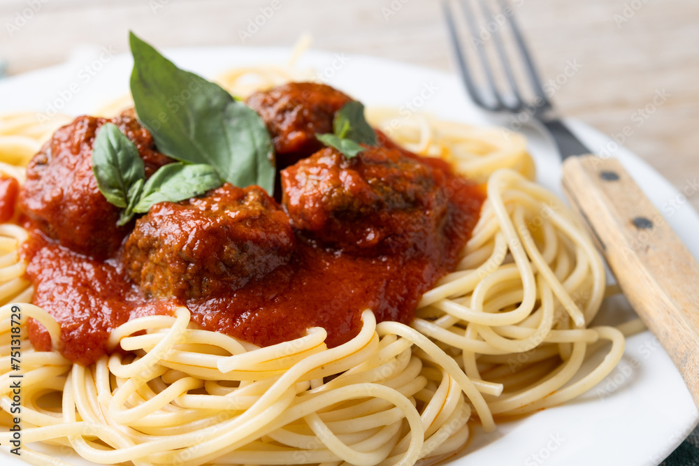 Spaghetti with meatballs on wooden table. Close up Spaghetti with meatballs on wooden table. Close up