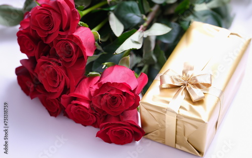 Gift golden box for valentine day with red roses. Beautiful bouquet of flowers and surprise box
