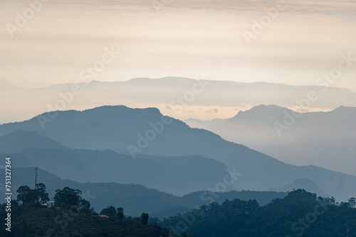 Layered hills of Kodaikanal enveloped in early morning mist, showcasing tranquil scenery. © Balaji