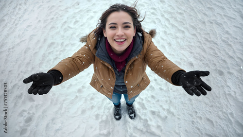 Snow falling over a beautiful woman looking up the sky