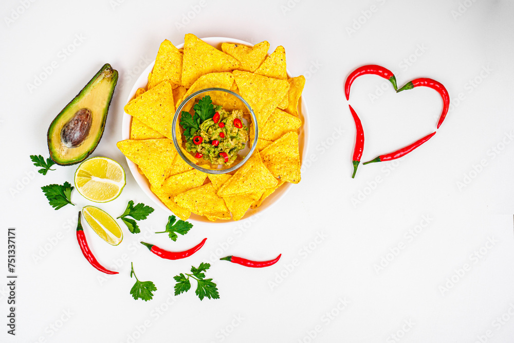 Nachos. Crispy tortilla chips topped with melted cheddar cheese, salsa,pepper, jalapeno, guacamole, lime and garlic. Classic traditional Tex-Mex or Mexican restaurant menu item. Chili pepper heart