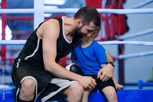 Father hugs and consoles his child after sports defeat. Concept help and emotional support in family sport