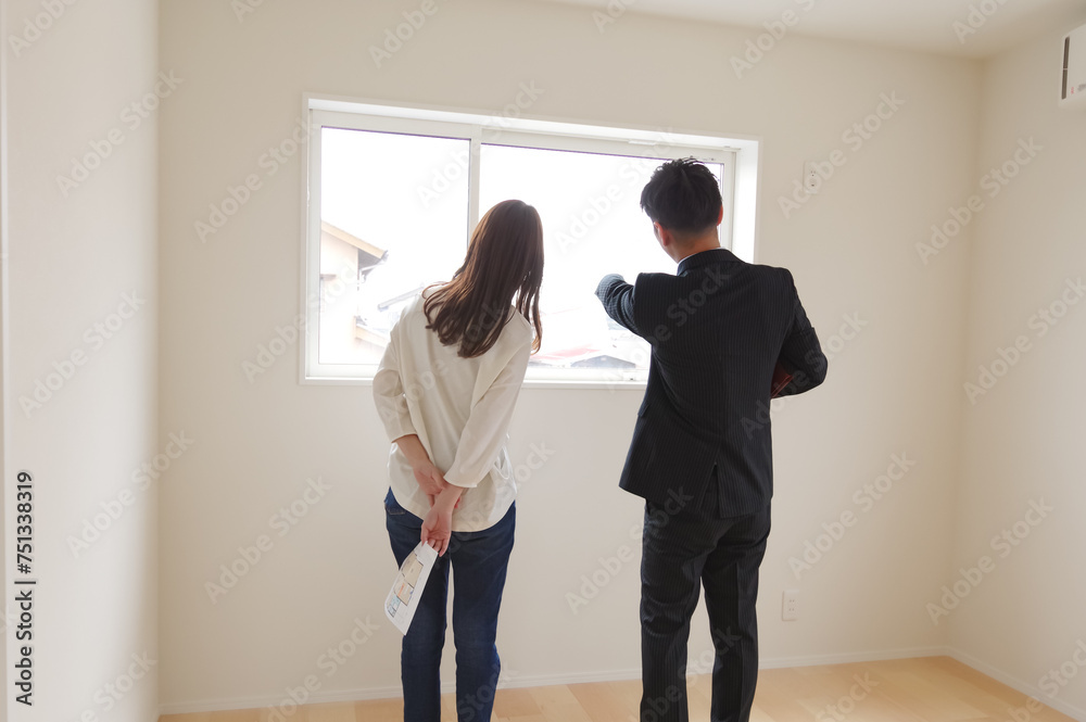 Fototapeta premium 不動産の案内をしている男性と女性