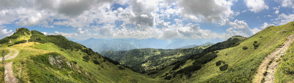 Naklejka premium Panoramic View of Green Hilly Nature in Austria. Panorama of a Beautiful Scenery of European Mountains during Summer Day.