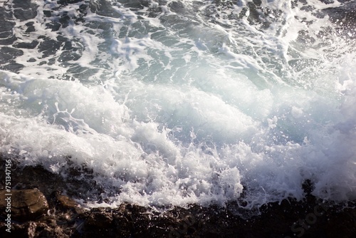 Sea waves spattering on the rocky shore © tegamichi