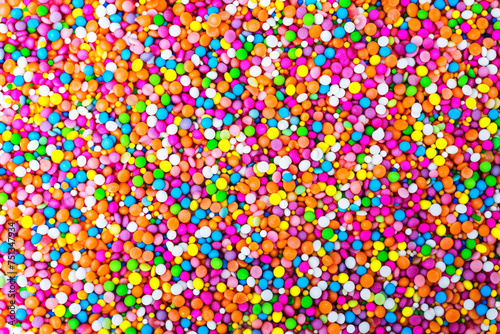 Large quantity of vibrant sprinkles scattered on a clean white background