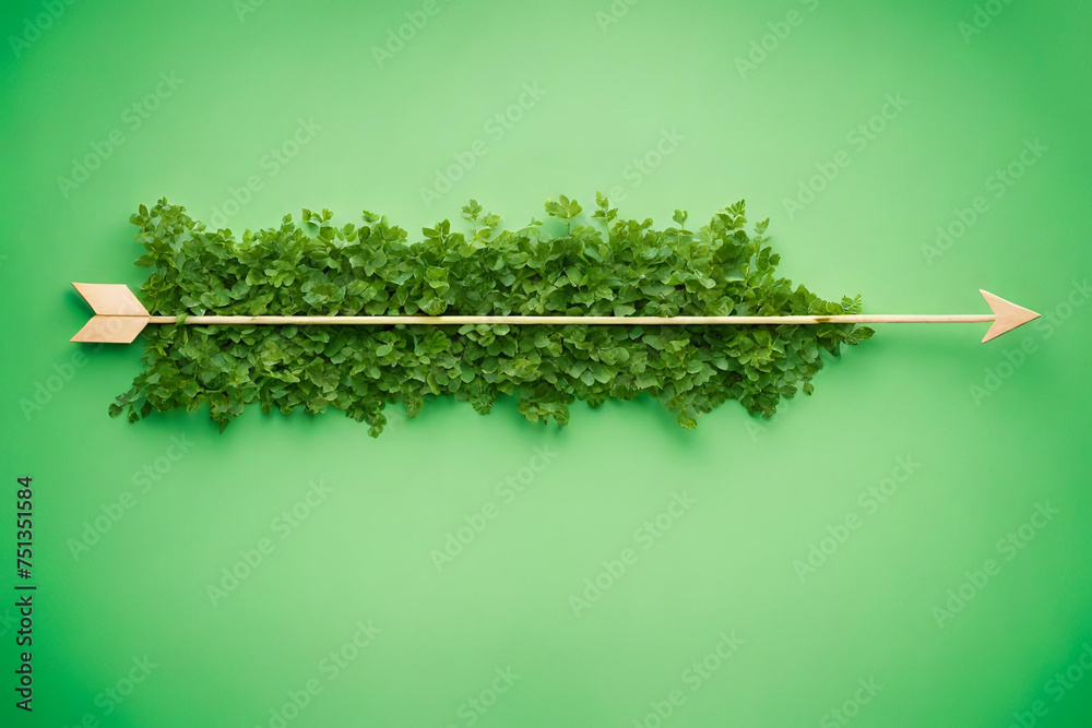 Arrow covered with green plants against green background