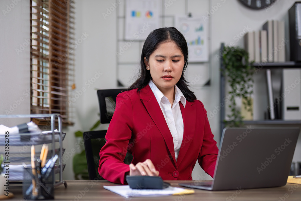 A determined businesswoman is sitting with stress in her home office. A determined businesswoman is sitting with stress in her home office.