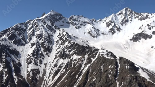 Mountains of the main Caucasian ridge on a sunny cloudless day. Kabardino-Balkaria, Russia photo