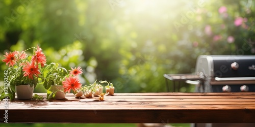 summer time in backyard garden with grill BBQ, wooden table, blurred background © Coosh448
