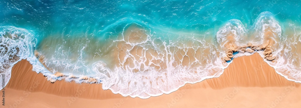 a blue ocean waves on a sandy beach