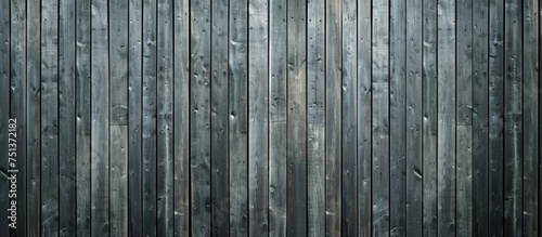 A black and white photograph showcasing the intricacies of a wooden wall made up of gray boards. The texture is detailed and raw, highlighting the natural beauty of the wood. photo