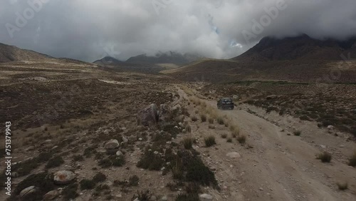 Drone: flies behind a car through a gorge in the mountains of Kyrgyzstan