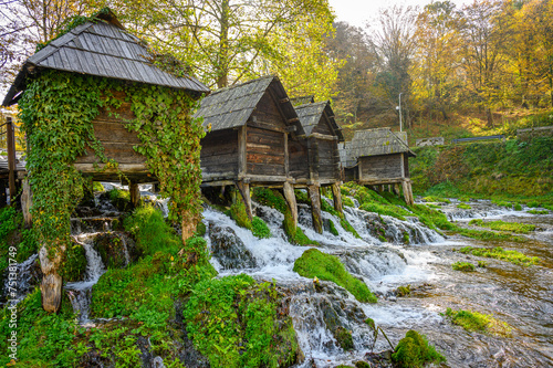 Old small wooden water mills called Mlincici built on Pliva lake near Jajce, Bosnia and Herzegovina.