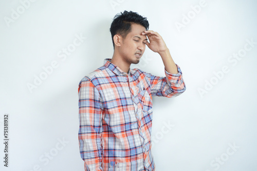 Adult Asian man got painful migrain gesture photo