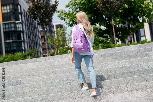 Photo of gorgeous pretty woman walking in city center exploring new town summertime outside