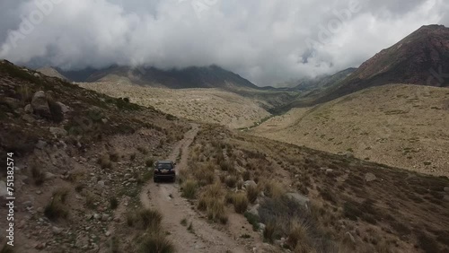 Drone: flies behind a car through a gorge in the mountains of Kyrgyzstan