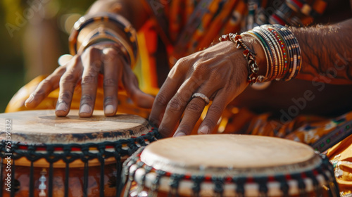 Close-up of a musician's hands playing a traditional drum with intricate details, adorned with colorful bracelets and a ring, blending cultural music with vibrant attire indicative of rich heritage. photo