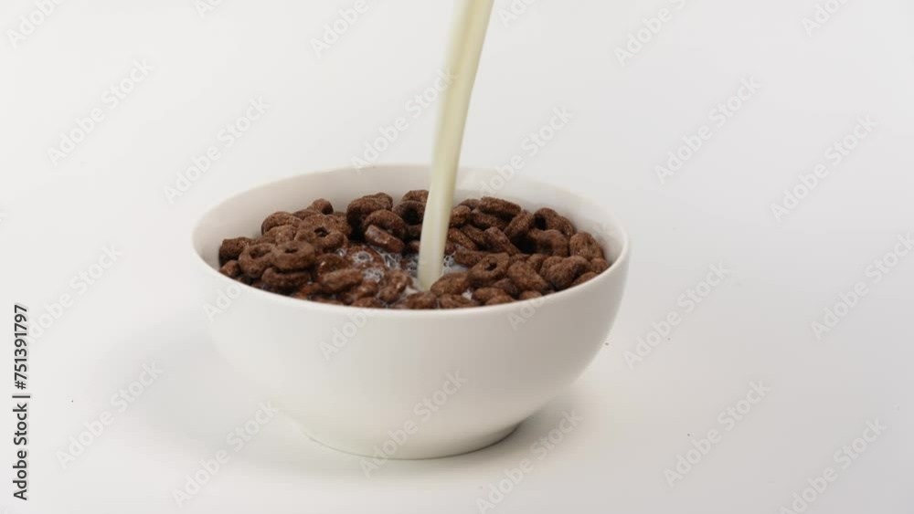 Cereals and milk. Milk being poured on flakes. Chocolate rings on white background. Healthy nutrition and people concept. breakfast cereals. Healthy food. Cereals in white bowl. Cereals and milk. Milk being poured on flakes. Chocolate rings on white background. Healthy nutrition and people concept. breakfast cereals. Healthy food. Cereals in white bowl.
