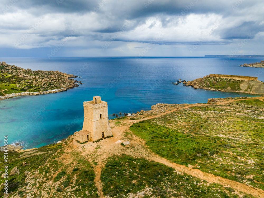 Drone aerial view of tower. Maltese nature landscape, stormy sky, sea. Malta 