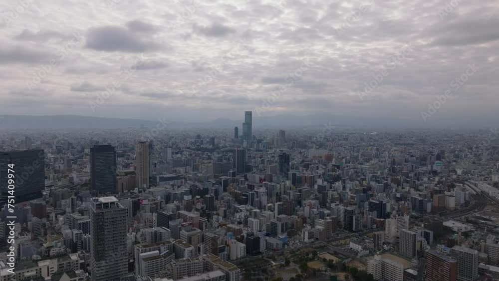 Metropolis from height. Fly above buildings in urban borough in large city in flat landscape. Osaka, Japan Metropolis from height. Fly above buildings in urban borough in large city in flat landscape. Osaka, Japan