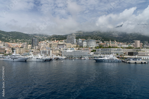View of Monaco with its harbor and its many luxury yachts, its buildings and mountains in the background. © Alexandre Prevot