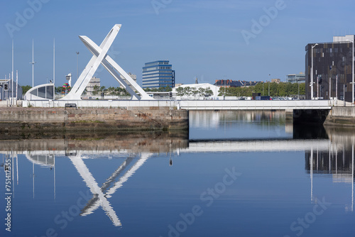 View of a modern steel swing bridge with a span of 35m build in 2006 and reflections on the water. photo