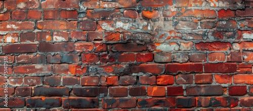 A close-up view of an old red brick wall with peeling paint. The weathered bricks show signs of decay and neglect  creating a sense of urban decay.
