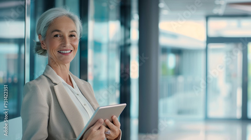 Pretty older business woman, successful confidence with arms crossed in financial building