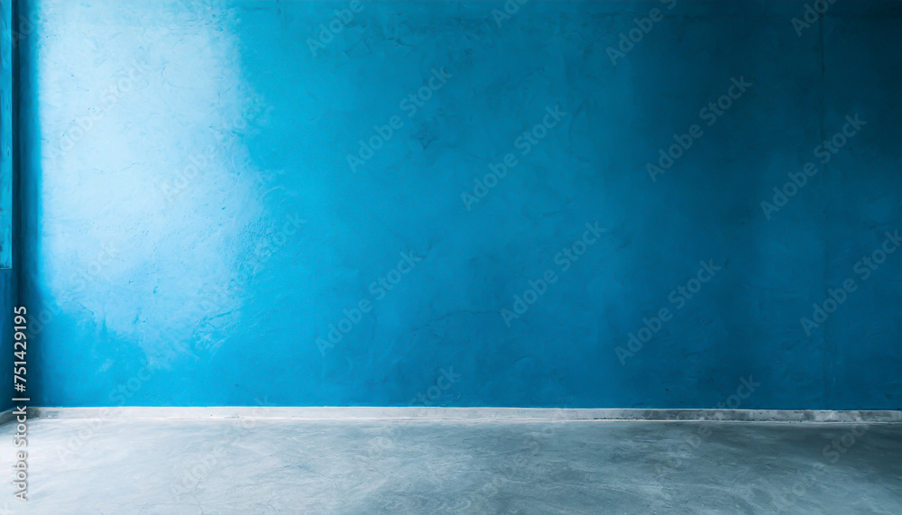 Blue wall in an empty room with concrete floor Blue wall in an empty room with concrete floor