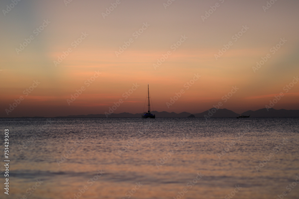 Sailboat in the distance during sunset