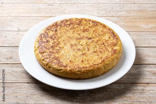 Traditional spanish omelette on wooden table.