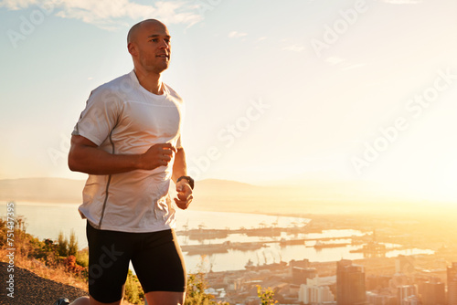 Fitness, running and man on hill at sunset for health, wellness and strong body development. Workout, exercise and runner on path in nature for marathon training, performance and outdoor challenge.