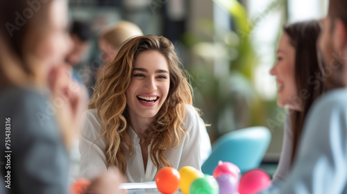  A candid photo shows a content businesswoman having fun with an Easter egg hunt in the office while her coworkers giggle around her