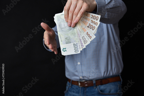Businessman holding banknotes in his hand. Czech Republic cash.