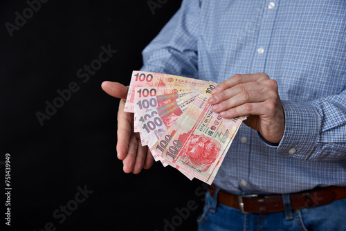 Businessman holding banknotes in his hand. Hong Kong dollars cash.