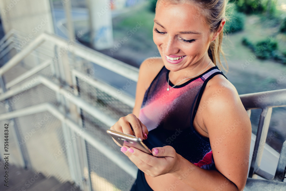 City, fitness and woman with smartphone, communication and smile typing after exercise low angle. Health, workout and personal trainer on phone, conversation and connect or network in sports training City, fitness and woman with smartphone, communication and smile typing after exercise low angle. Health, workout and personal trainer on phone, conversation and connect or network in sports training