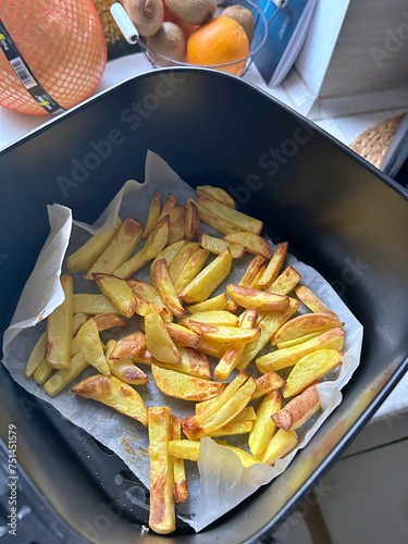 preparing fries in a deep fryer, potatoes cut into sticks, golden fries, crispy vegetables