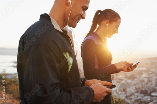 Earphones, cellphone and couple outdoor for fitness, music choice for workout and runner team with tech. Cardio, health and listening to radio with scroll on app, sports and motivation for exercise